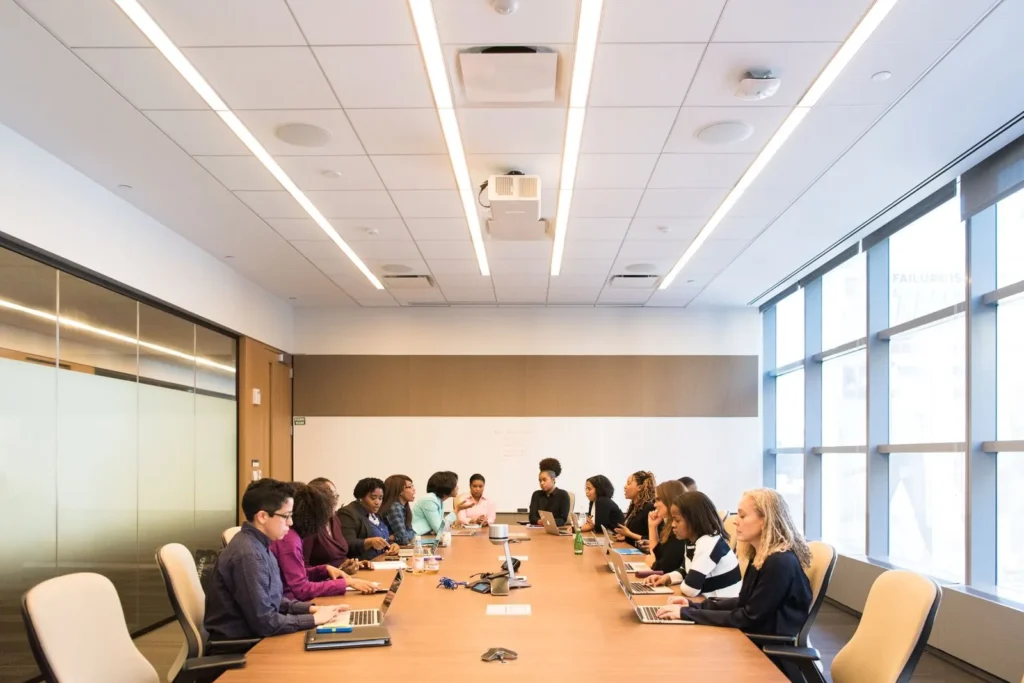 A team of colleagues around a long table in a bright meeting room