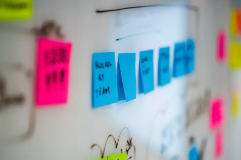 Colourful sticky notes on a whiteboard, in soft focus