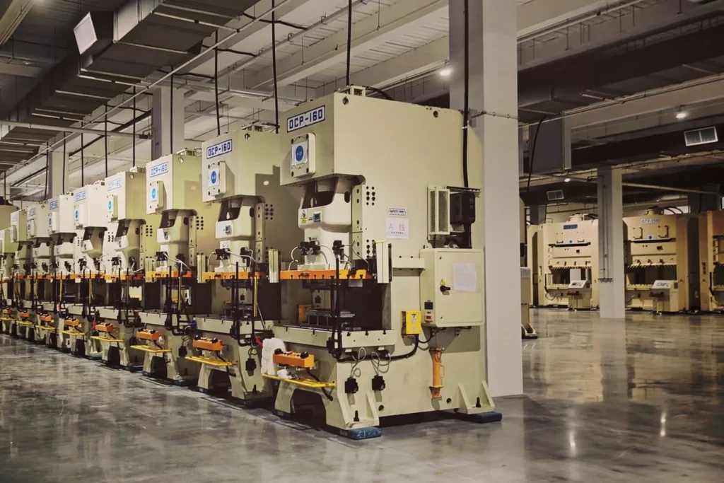 Rows of industrial press machines on a clean factory floor