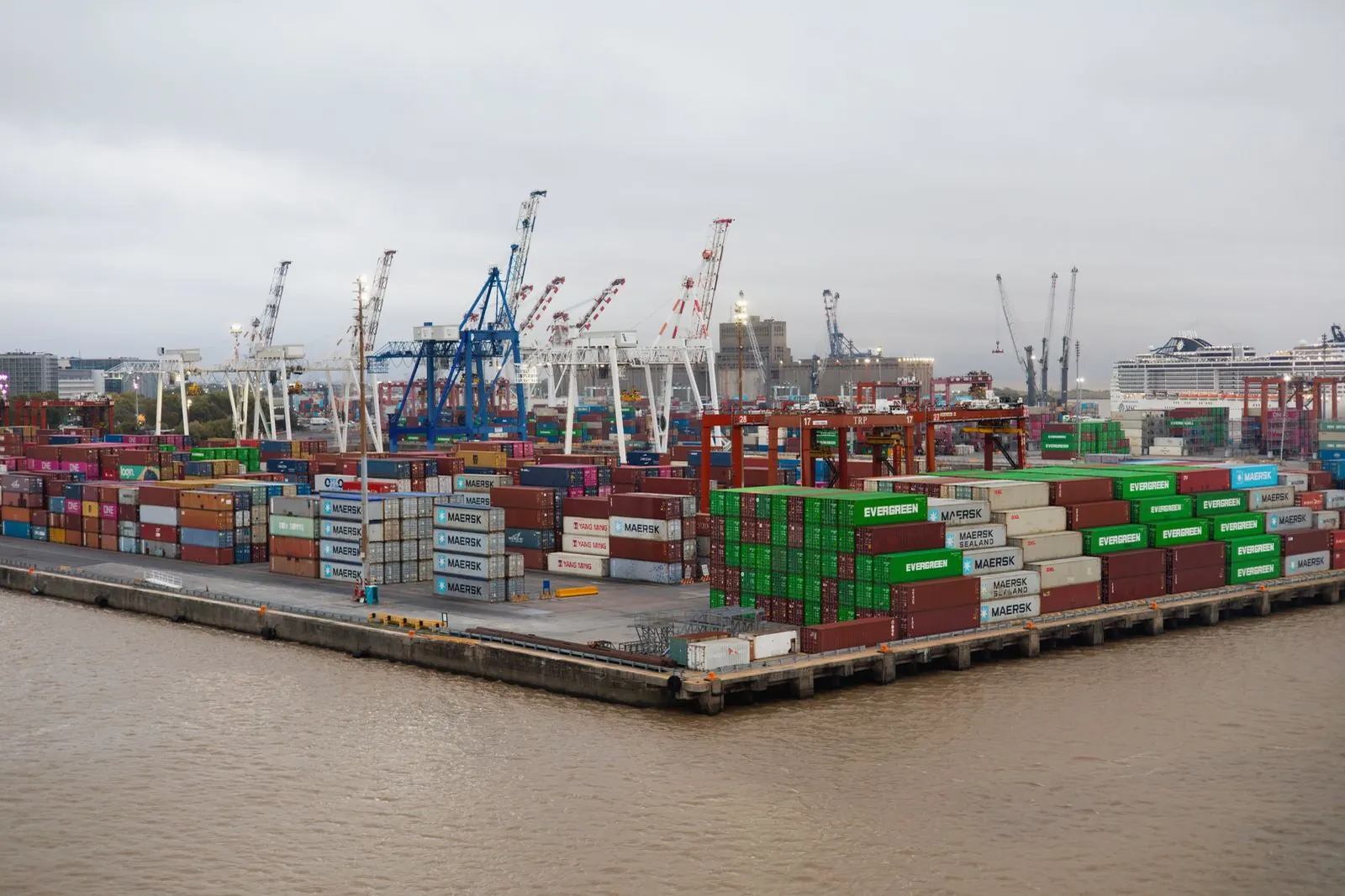 A container port with stacked shipping containers and cranes