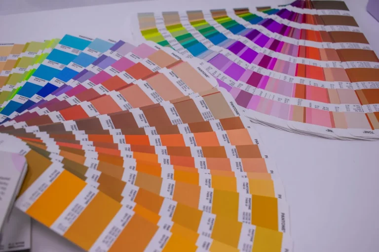Colour swatch guides fanned out across a table